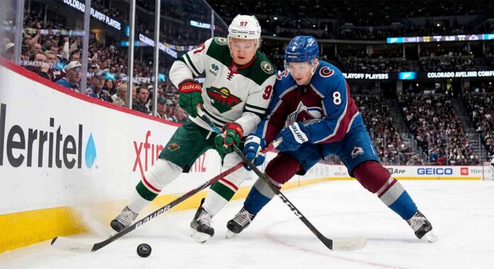 Cale Makar of the Colorado Avalanche and Kirill Kaprizov of the Minnesota Wild battle for the puck during Game 2 of their 2026 NHL playoff series.