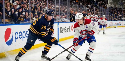 How to Watch Montreal Canadiens vs Buffalo Sabres Game 5 Tonight Montreal Canadiens Cole Caufield battles Buffalo Sabres Rasmus Dahlin for a loose puck during 2026 NHL Playoffs action at KeyBank Center.