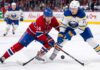 ction shot from the 2026 NHL Playoffs showing Montreal Canadiens forward Nick Suzuki (#14) battling for the puck with a stick check against Buffalo Sabres forward Tage Thompson (#72) during an intense game.