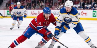 ction shot from the 2026 NHL Playoffs showing Montreal Canadiens forward Nick Suzuki (#14) battling for the puck with a stick check against Buffalo Sabres forward Tage Thompson (#72) during an intense game.