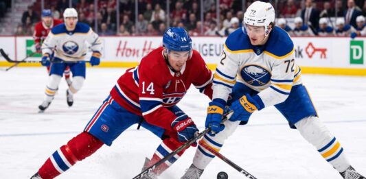 ction shot from the 2026 NHL Playoffs showing Montreal Canadiens forward Nick Suzuki (#14) battling for the puck with a stick check against Buffalo Sabres forward Tage Thompson (#72) during an intense game.