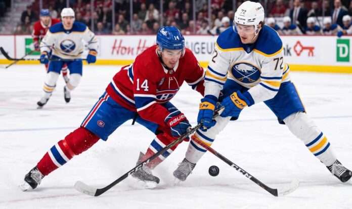 ction shot from the 2026 NHL Playoffs showing Montreal Canadiens forward Nick Suzuki (#14) battling for the puck with a stick check against Buffalo Sabres forward Tage Thompson (#72) during an intense game.
