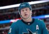 Toronto Maple Leafs & San Jose Sharks: Morgan Rielly Trade Rumors A conceptual image of long-time Toronto Maple Leafs defenseman Morgan Rielly wearing a teal San Jose Sharks home uniform and helmet, visualizing recent NHL trade rumors.