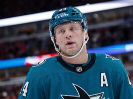 Toronto Maple Leafs & San Jose Sharks: Morgan Rielly Trade Rumors A conceptual image of long-time Toronto Maple Leafs defenseman Morgan Rielly wearing a teal San Jose Sharks home uniform and helmet, visualizing recent NHL trade rumors.