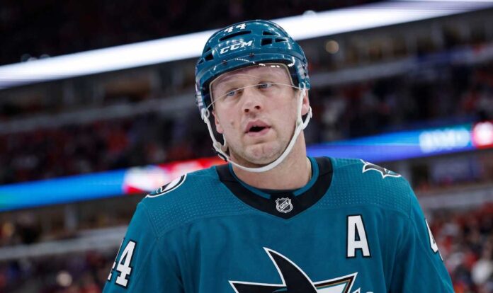 A conceptual image of long-time Toronto Maple Leafs defenseman Morgan Rielly wearing a teal San Jose Sharks home uniform and helmet, visualizing recent NHL trade rumors.