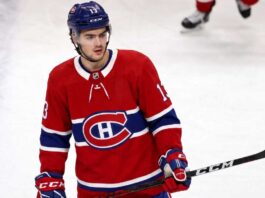 Montreal Canadiens Linked to New Jersey Devils’ Nico Hischier A conceptual jersey swap photograph featuring Nico Hischier on the ice wearing a red Montreal Canadiens home uniform, holding a stick, with number 13 on his blue CCM helmet.