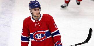 Montreal Canadiens Linked to New Jersey Devils’ Nico Hischier A conceptual jersey swap photograph featuring Nico Hischier on the ice wearing a red Montreal Canadiens home uniform, holding a stick, with number 13 on his blue CCM helmet.