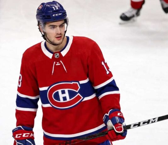 Montreal Canadiens Linked to New Jersey Devils’ Nico Hischier A conceptual jersey swap photograph featuring Nico Hischier on the ice wearing a red Montreal Canadiens home uniform, holding a stick, with number 13 on his blue CCM helmet.