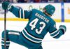 San Jose Sharks free agency target defenseman Darren Raddysh celebrating a goal in a conceptual teal home uniform on the ice with his stick raised.