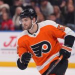 Philadelphia Flyers Trade Rumors: Targeting Shane Wright from Seattle Kraken NHL center Shane Wright pictured wearing a Philadelphia Flyers orange home jersey, illustrating potential NHL trade rumors connecting the Seattle Kraken forward to Philadelphia.