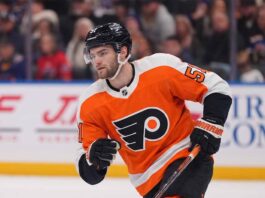 NHL center Shane Wright pictured wearing a Philadelphia Flyers orange home jersey, illustrating potential NHL trade rumors connecting the Seattle Kraken forward to Philadelphia.