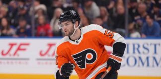 NHL center Shane Wright pictured wearing a Philadelphia Flyers orange home jersey, illustrating potential NHL trade rumors connecting the Seattle Kraken forward to Philadelphia.