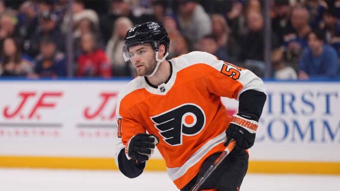 NHL center Shane Wright pictured wearing a Philadelphia Flyers orange home jersey, illustrating potential NHL trade rumors connecting the Seattle Kraken forward to Philadelphia.