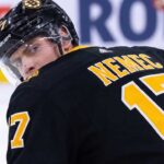 Simon Nemec looking back over his shoulder wearing a black Boston Bruins home jersey with number 17, illustrating NHL trade rumors linking him to Boston.