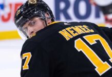 Boston Bruins Trade Rumors: Targeting Devils Defenseman Simon Nemec Simon Nemec looking back over his shoulder wearing a black Boston Bruins home jersey with number 17, illustrating NHL trade rumors linking him to Boston.