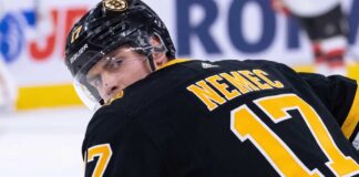 Simon Nemec looking back over his shoulder wearing a black Boston Bruins home jersey with number 17, illustrating NHL trade rumors linking him to Boston.