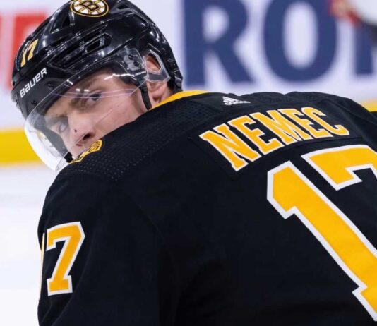Simon Nemec looking back over his shoulder wearing a black Boston Bruins home jersey with number 17, illustrating NHL trade rumors linking him to Boston.