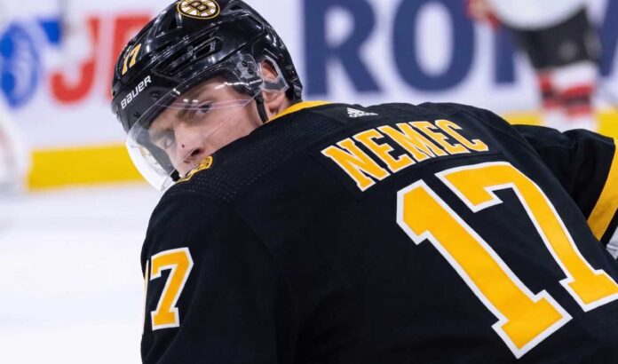 Simon Nemec looking back over his shoulder wearing a black Boston Bruins home jersey with number 17, illustrating NHL trade rumors linking him to Boston.