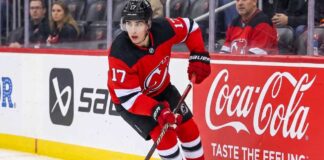 New Jersey Devils defenseman Simon Nemec #17 skating with the puck during play.