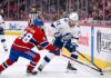Tampa Bay Lightning forward Brayden Point battles Montreal Canadiens defenseman Lane Hutson for puck control near the boards at the Bell Centre during Game 6 of the 2026 Stanley Cup Playoffs.
