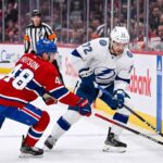 Tampa Bay Lightning forward Brayden Point battles Montreal Canadiens defenseman Lane Hutson for puck control near the boards at the Bell Centre during Game 6 of the 2026 Stanley Cup Playoffs.