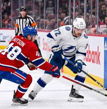 Tampa Bay Lightning forward Brayden Point battles Montreal Canadiens defenseman Lane Hutson for puck control near the boards at the Bell Centre during Game 6 of the 2026 Stanley Cup Playoffs.