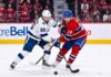 Nikita Kucherov (#86) of the Tampa Bay Lightning and Nick Suzuki (#14) of the Montreal Canadiens battle intensely for the puck during Game 6 of their Eastern Conference Quarterfinal series at Centre Bell in Montreal.