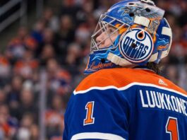 Edmonton Oilers Trade Rumors: Ukka-Pekka Luukkonen Sabres Deal A close-up profile view of Buffalo Sabres goaltender Ukko-Pekka Luukkonen, wearing his custom-painted goalie mask and blue jersey with 'LUUKKONEN' visible on the back. This image is used in an analysis of a potential trade linking him to the Edmonton Oilers.