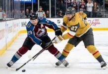 How to Watch Vegas Golden Knights vs Colorado Avalanche Game 2 Tonight An action shot of Nathan MacKinnon (#29) of the Colorado Avalanche battling Shea Theodore (#27) of the Vegas Golden Knights in a crucial playoff game face-off.