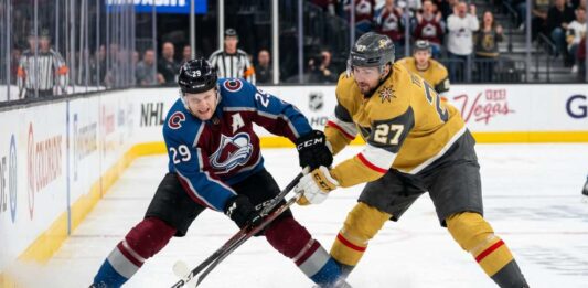 How to Watch Vegas Golden Knights vs Colorado Avalanche Game 2 Tonight An action shot of Nathan MacKinnon (#29) of the Colorado Avalanche battling Shea Theodore (#27) of the Vegas Golden Knights in a crucial playoff game face-off.