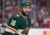 Minnesota Wild Trade Rumors: Will They Acquire Vincent Trocheck? A close-up portrait of Vincent Trocheck wearing a forest green Minnesota Wild home jersey with the number 16, illustrating the recent trade rumors connecting him to the team from the New York Rangers.