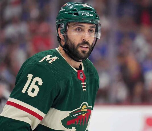 Minnesota Wild Trade Rumors: Will They Acquire Vincent Trocheck? A close-up portrait of Vincent Trocheck wearing a forest green Minnesota Wild home jersey with the number 16, illustrating the recent trade rumors connecting him to the team from the New York Rangers.