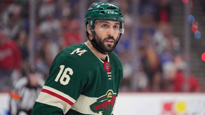 A close-up portrait of Vincent Trocheck wearing a forest green Minnesota Wild home jersey with the number 16, illustrating the recent trade rumors connecting him to the team from the New York Rangers.