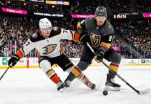 Anaheim Ducks and Vegas Golden Knights hockey players battle for the puck during Game 5 of the 2026 Western Conference Semi-Finals at T-Mobile Arena in Las Vegas.
