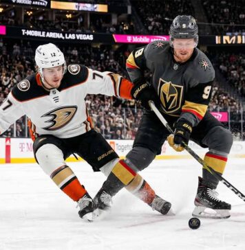 Anaheim Ducks and Vegas Golden Knights hockey players battle for the puck during Game 5 of the 2026 Western Conference Semi-Finals at T-Mobile Arena in Las Vegas.