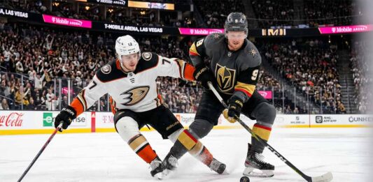 How to Watch Anaheim Ducks vs. Vegas Golden Knights Game 5 Tonight Anaheim Ducks and Vegas Golden Knights hockey players battle for the puck during Game 5 of the 2026 Western Conference Semi-Finals at T-Mobile Arena in Las Vegas.