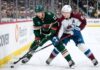 Minnesota Wild's Matt Boldy and Colorado Avalanche's Cale Makar battle for the puck in a crucial NHL playoff game.