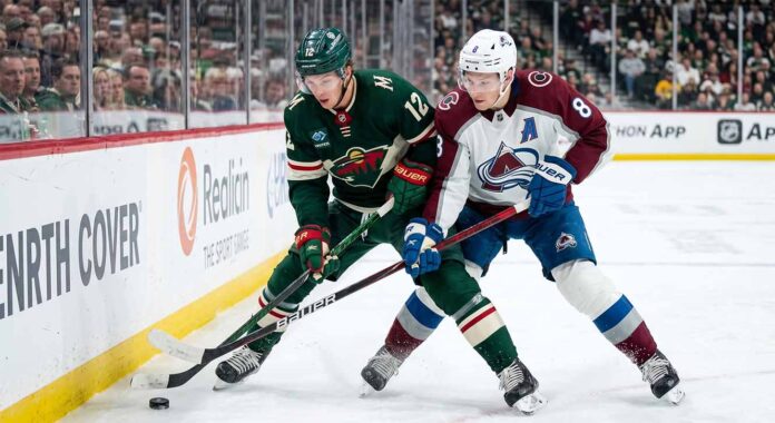 wild-avalanche-game-5-2026-nhl-playoffs Minnesota Wild's Matt Boldy and Colorado Avalanche's Cale Makar battle for the puck in a crucial NHL playoff game.