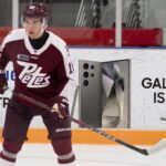 Washington Capitals 2026 NHL Draft: Why Adam Novotny Makes Sense at #18 A photograph of Peterborough Petes forward Adam Novotny (#16) skating with a powerful stance on the ice.