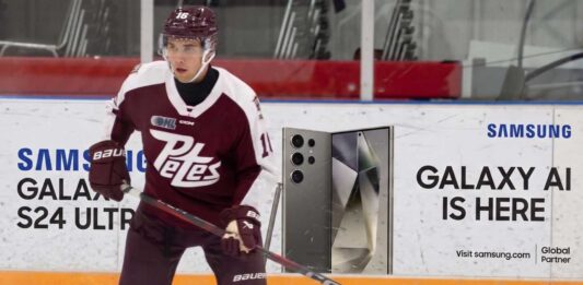A photograph of Peterborough Petes forward Adam Novotny (#16) skating with a powerful stance on the ice.