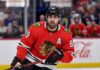 Chicago Blackhawks Free Agency: Why Alex Tuch is the Perfect Fit Speculative image projection of Alex Tuch in a Chicago Blackhawks red home jersey, an ideal NHL free agent target and potential new linemate for Connor Bedard.
