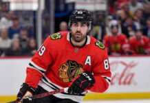 Chicago Blackhawks Free Agency: Why Alex Tuch is the Perfect Fit Speculative image projection of Alex Tuch in a Chicago Blackhawks red home jersey, an ideal NHL free agent target and potential new linemate for Connor Bedard.