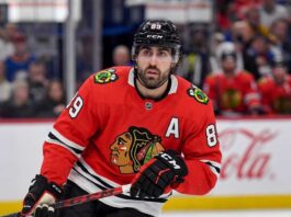 Speculative image projection of Alex Tuch in a Chicago Blackhawks red home jersey, an ideal NHL free agent target and potential new linemate for Connor Bedard.