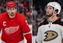 Anaheim Ducks Linked to Detroit Red Wings Captain Dylan Larkin in Blockbuster Rumor Split image featuring Detroit Red Wings captain Dylan Larkin in a red jersey and Anaheim Ducks young center Mason McTavish in a white jersey, illustrating the rumored NHL trade scenario.