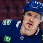 Brendan Gallagher Leaving Montreal Canadiens: Vancouver Canucks Rumors Conceptually rendered photo of former Montreal Canadiens winger Brendan Gallagher in a Vancouver Canucks home uniform, visualizing trade and buyout rumors.