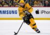 Pittsburgh Penguins Bryan Rust Trade Rumors & Updates A photo of Pittsburgh Penguins forward and alternate captain Bryan Rust skating with the hockey puck in the team's yellow and black uniform during a game.