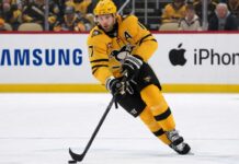 Pittsburgh Penguins Bryan Rust Trade Rumors & Updates A photo of Pittsburgh Penguins forward and alternate captain Bryan Rust skating with the hockey puck in the team's yellow and black uniform during a game.