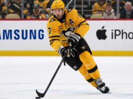 Pittsburgh Penguins Bryan Rust Trade Rumors & Updates A photo of Pittsburgh Penguins forward and alternate captain Bryan Rust skating with the hockey puck in the team's yellow and black uniform during a game.