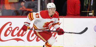 Calgary Flames Trade Rumors: Connor Zary Available for 2nd-Round Pick Calgary Flames forward Connor Zary (#47) skating with the puck past a Coca-Cola board advertisement during an NHL game amid recent NHL trade rumors.