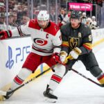 Carolina Hurricanes and Vegas Golden Knights puck battle featuring captains Jordan Staal (#11, 'C') and Jack Eichel (#9, 'A') along the boards during Game 6 of the 2026 Stanley Cup Final.